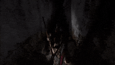 a person in a dark room with a sword