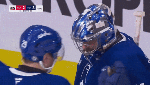 a hockey game is being played and the score is 3 to 2