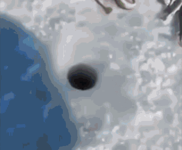 a close up of a hole in the ice