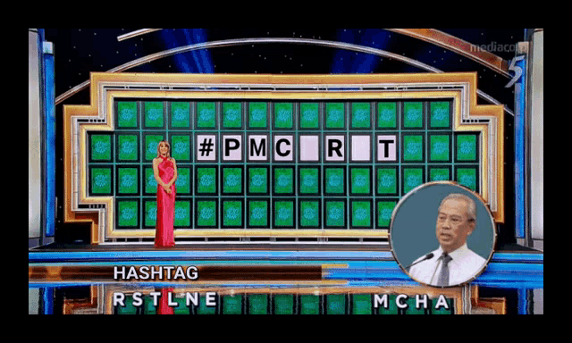 a woman in a red dress is standing in front of a wheel of fortune game board