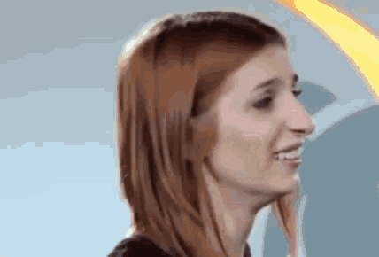 a close up of a woman 's face with red hair .