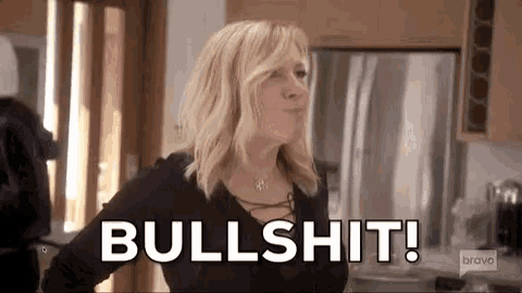 a woman is standing in a kitchen and saying bullshit .