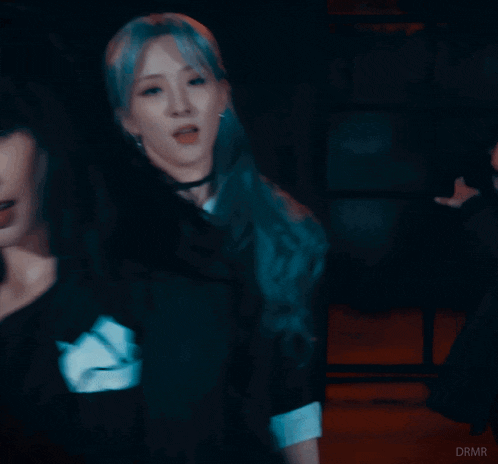 a blurry picture of two women dancing with the word diva in the corner