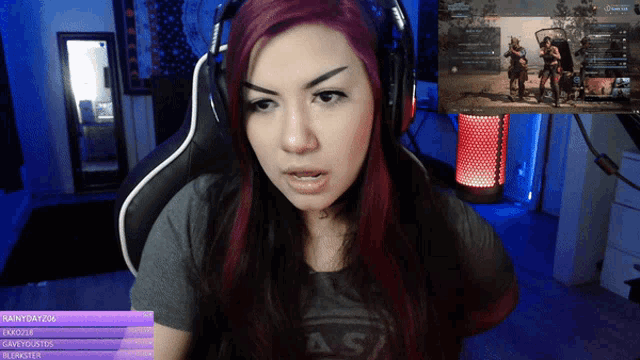 a woman wearing headphones is sitting in front of a screen that says as