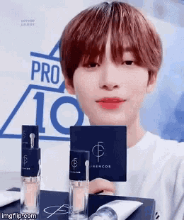 a young man is holding a card with the number 10 on it