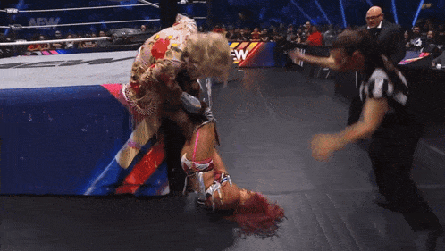 a woman in a wrestling ring with the word aew on the bottom right