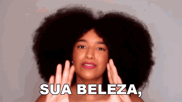 a woman with a big afro has the words sua beleza on her face