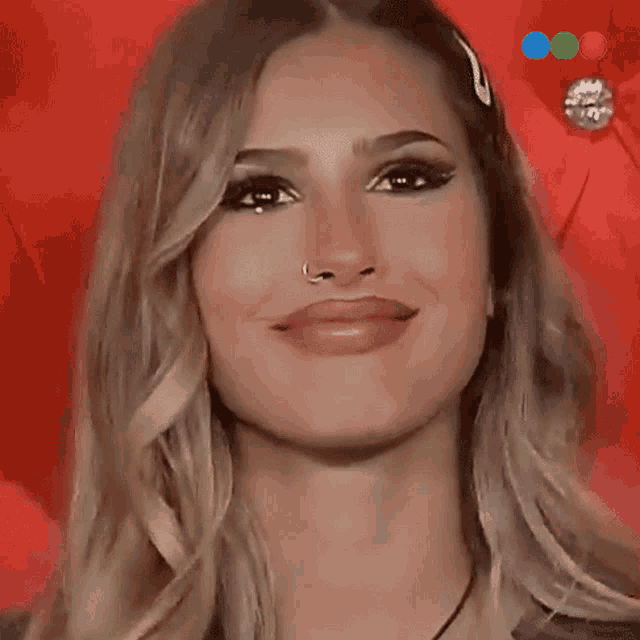 a close up of a woman 's face with a red background