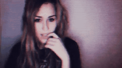 a blurred image of a woman with her hand on her face