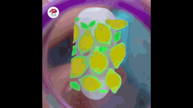 a woman 's nails are decorated with lemons and green leaves .