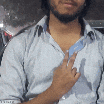 a man in a striped shirt is giving the peace sign