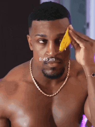 a man without a shirt is applying a yellow sponge to his face and the time is 8:45 am