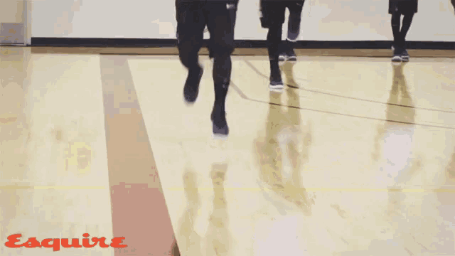 a person is running on a basketball court and the word esquire is on the bottom