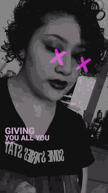 a black and white photo of a woman with pink x 's on her eyes