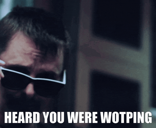 a man wearing sunglasses has the words heard you were wotping written below him