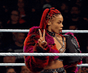 a woman in a fur coat giving the peace sign