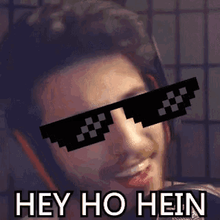 a man wearing sunglasses with the words hey ho hein on it .