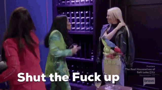 a group of women standing next to each other with the words shut the fuck up on the bottom .