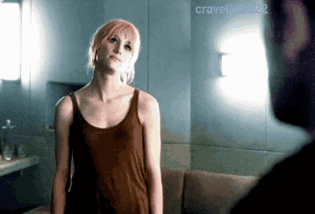 a woman with pink hair is standing in front of a mirror with the year 2022 written on the bottom
