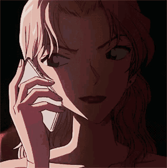 a woman talking on a cell phone with a shadow on her face