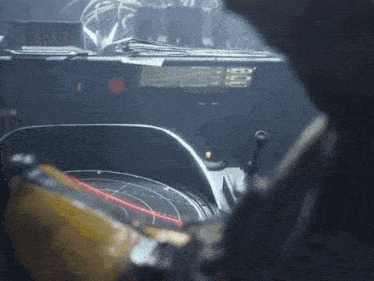 a close up of a steering wheel with a red light coming from it