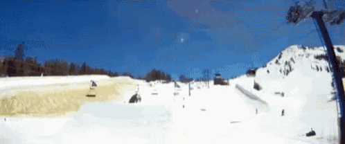 a ski lift is going up a snowy hill