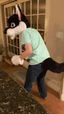 a man in a furry wolf costume stands in front of a door
