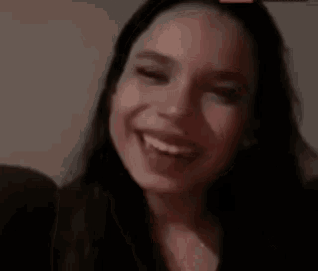 a close up of a woman 's face with a smile on her face .