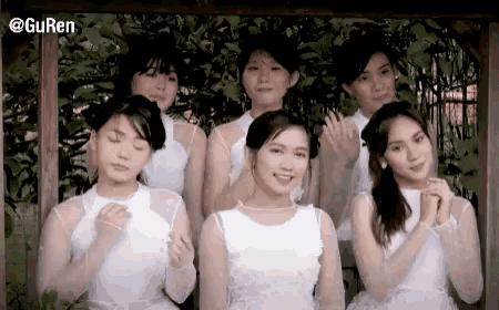 a group of girls in white dresses are posing for a picture with the caption @guren