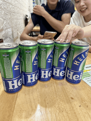 several cans of heineken beer are lined up on a table
