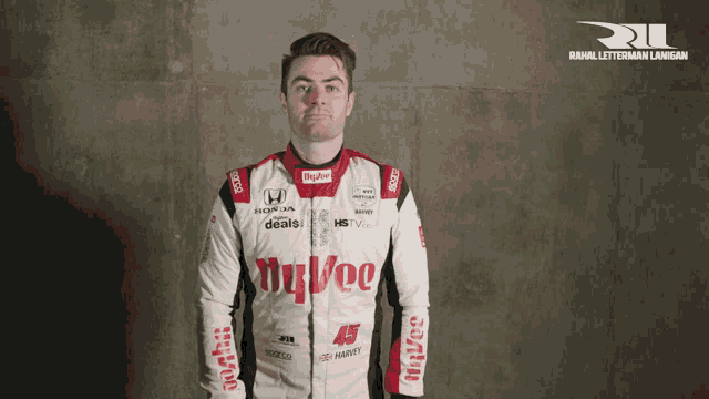 a man is wearing a white and red race suit with the word hyvee on it