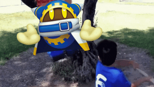 a boy in a blue shirt with the letter l on the back looks at a cartoon character