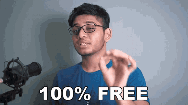 a man wearing glasses and a blue shirt is saying 100 % free in front of a microphone .