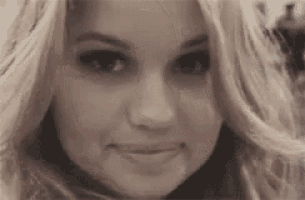 a close up of a woman 's face making a face .