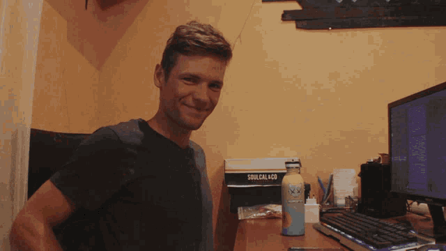 a man sitting at a desk with a box that says soulcal420