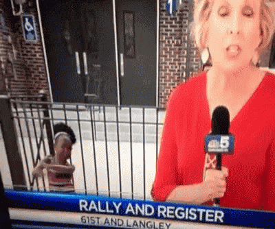 a news anchor is talking into a microphone with the words rally and register at the top