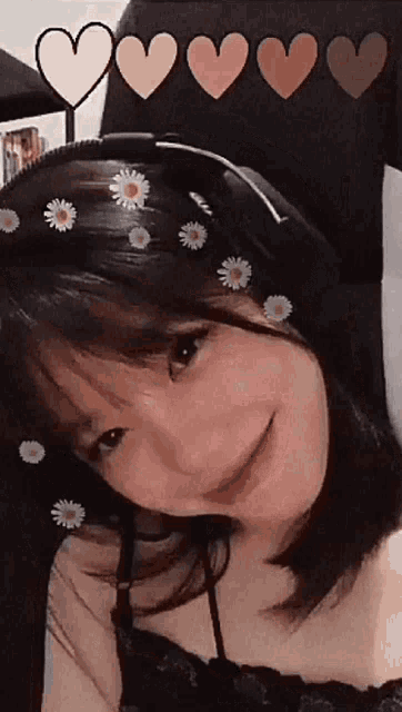 a girl wearing headphones and flowers on her head