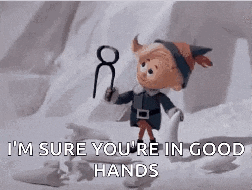 a cartoon elf is standing in the snow holding a pair of scissors and a ring .