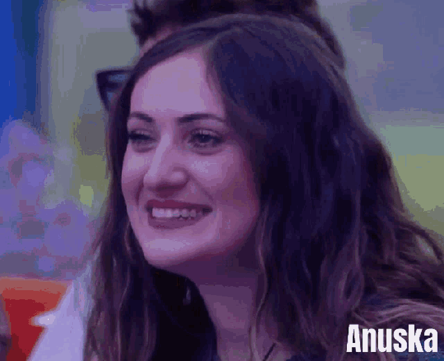 a close up of a woman 's face with the name anuska behind her