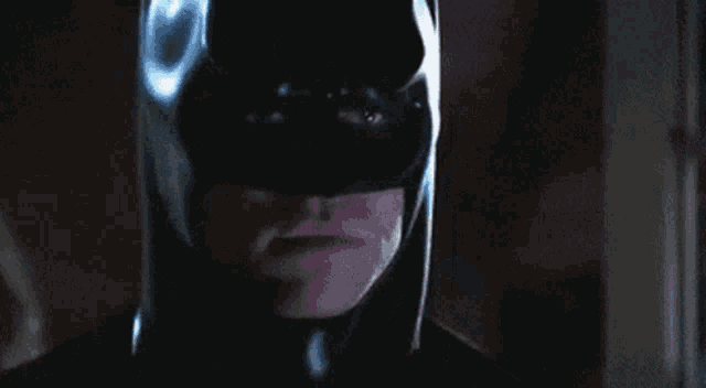 a close up of a man in a batman mask