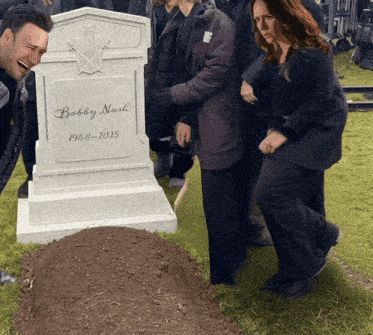 a group of people are standing around a grave of bobby nash