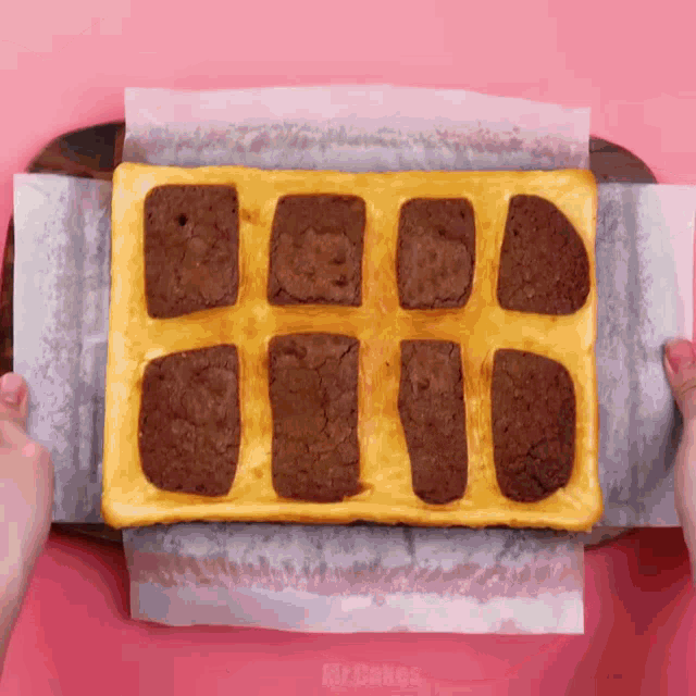 a person is holding a piece of food that says mr. cakes