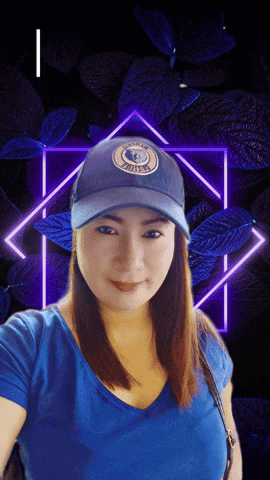a woman wearing a blue shirt and a hat that says ' aguila ' on it