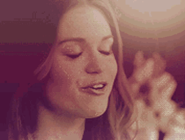 a close up of a woman with her eyes closed and her mouth open