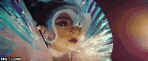 a close up of a woman 's face wearing a fan and a mask .