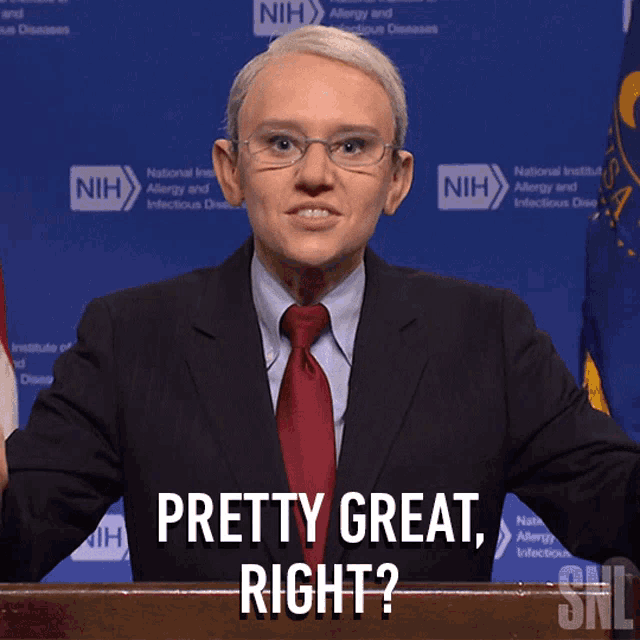a man in a suit and tie stands behind a podium and says " pretty great right "