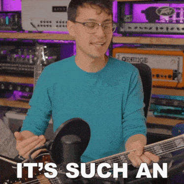 a man playing a guitar with the words it 's such an