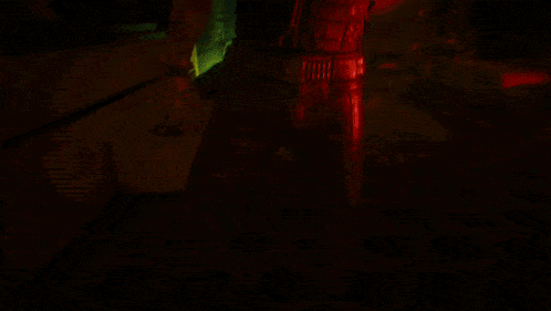 a blurry picture of a dark room with a red light coming out of the door