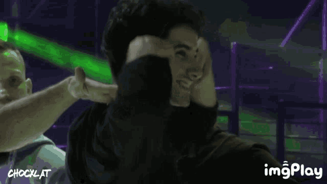 a man is covering his face with his hands and the word chockat is on the bottom