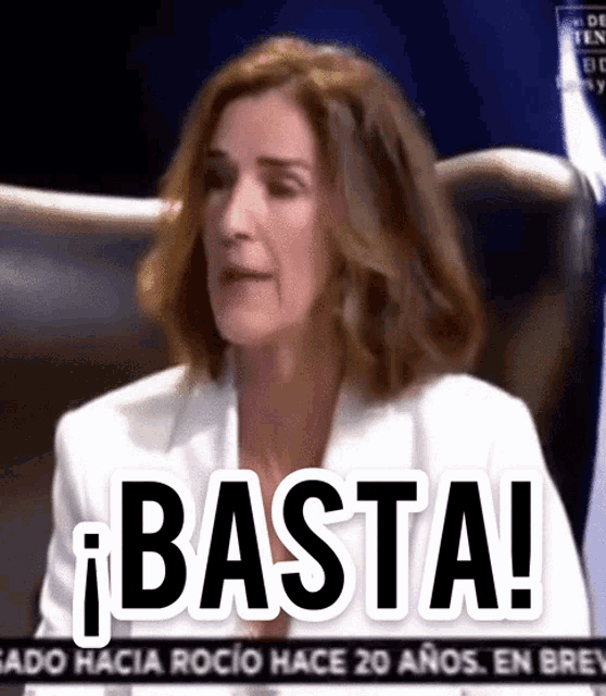 a woman is sitting in a chair with the word basta written on her face
